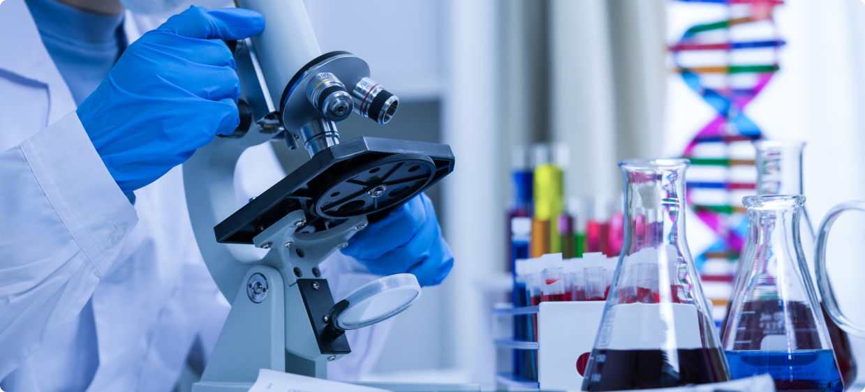 A microscope is shown in front of many bottles.